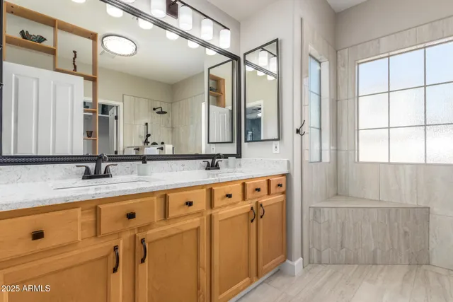 a bathroom with a granite countertop sink mirror and double