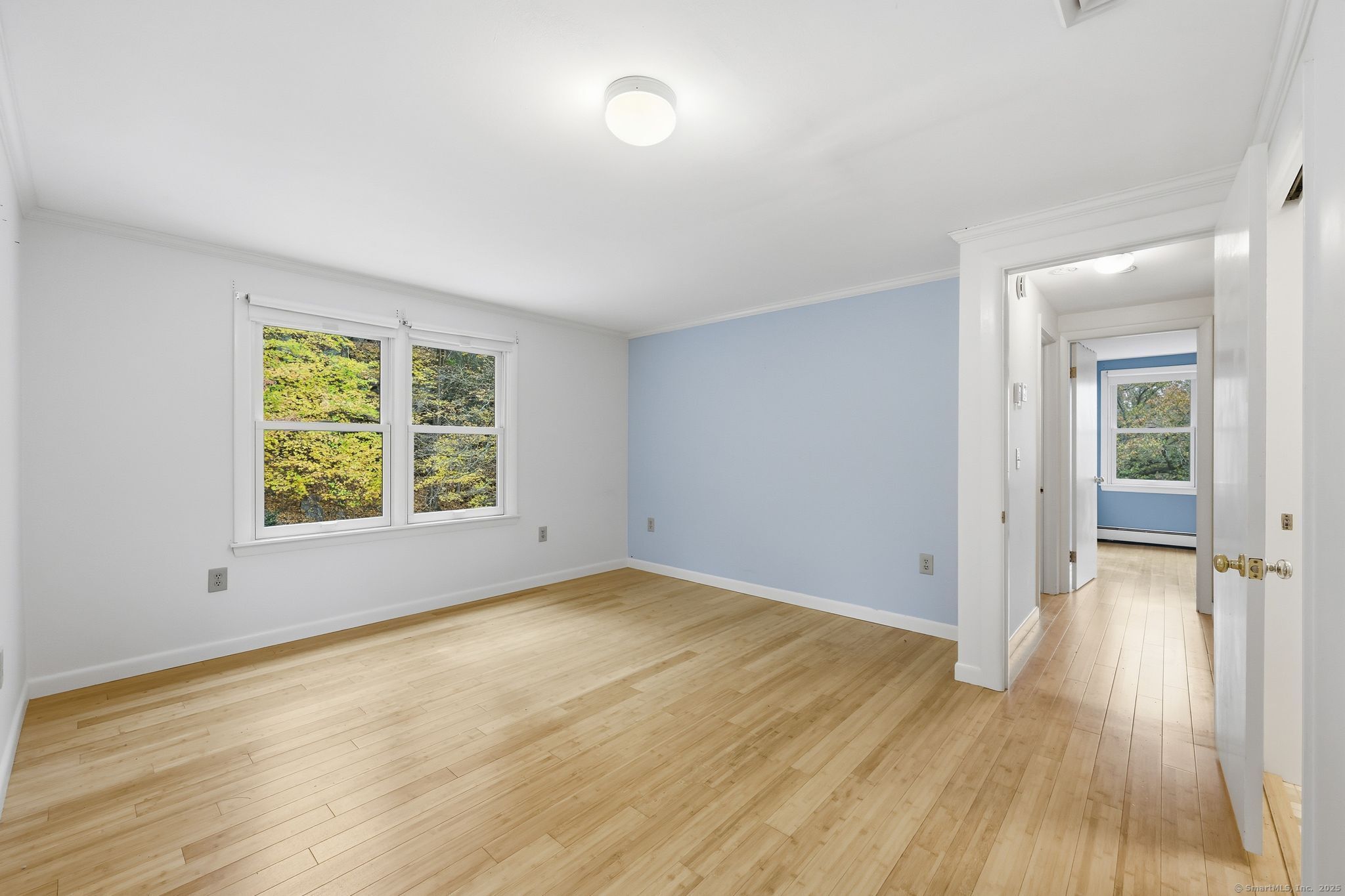 102 Lucas Park Road Norwich, CT 06360 - Photo 13 of 37 an empty room with wooden floor and windows
