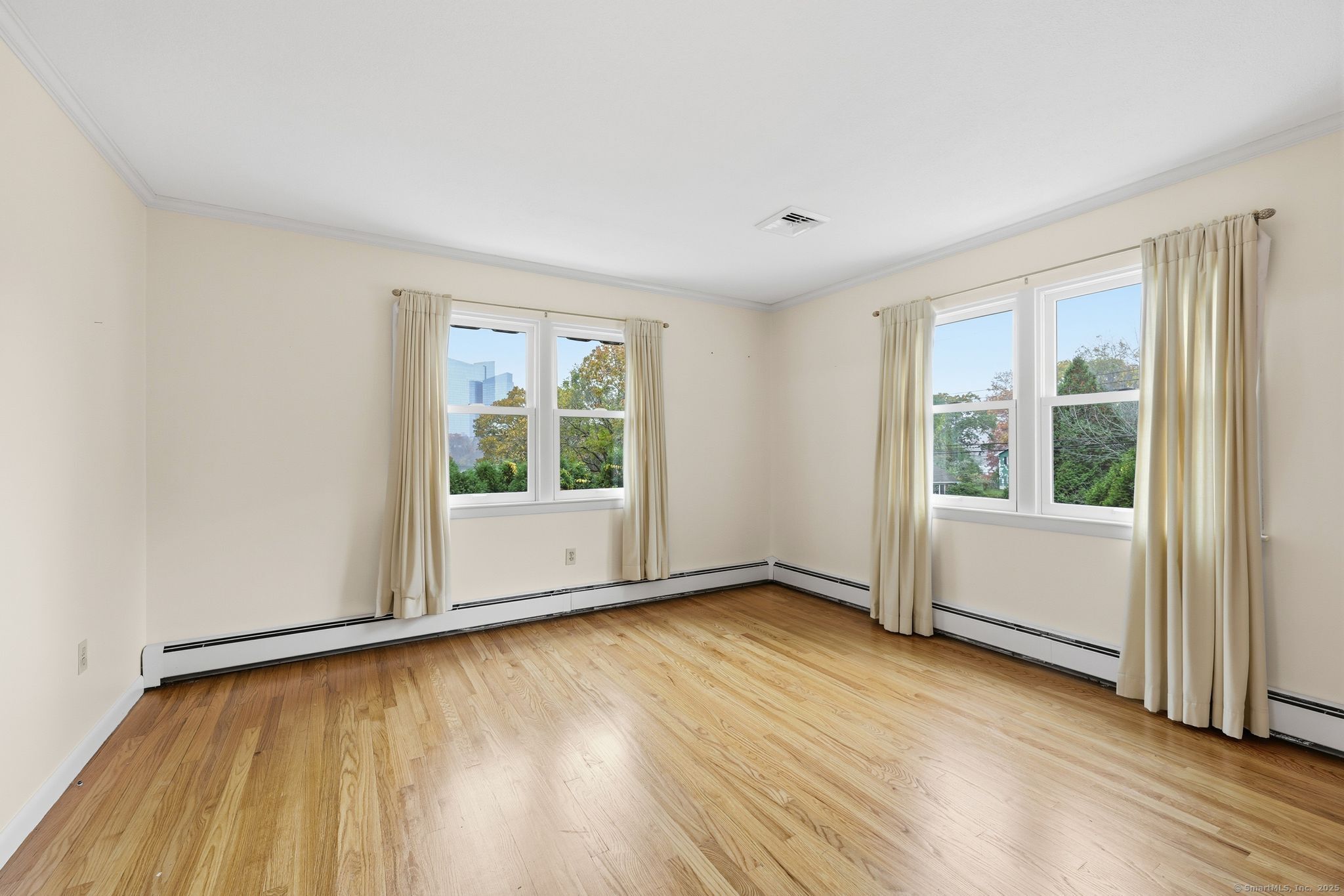 102 Lucas Park Road Norwich, CT 06360 - Photo 2 of 37 an empty room with wooden floor and windows
