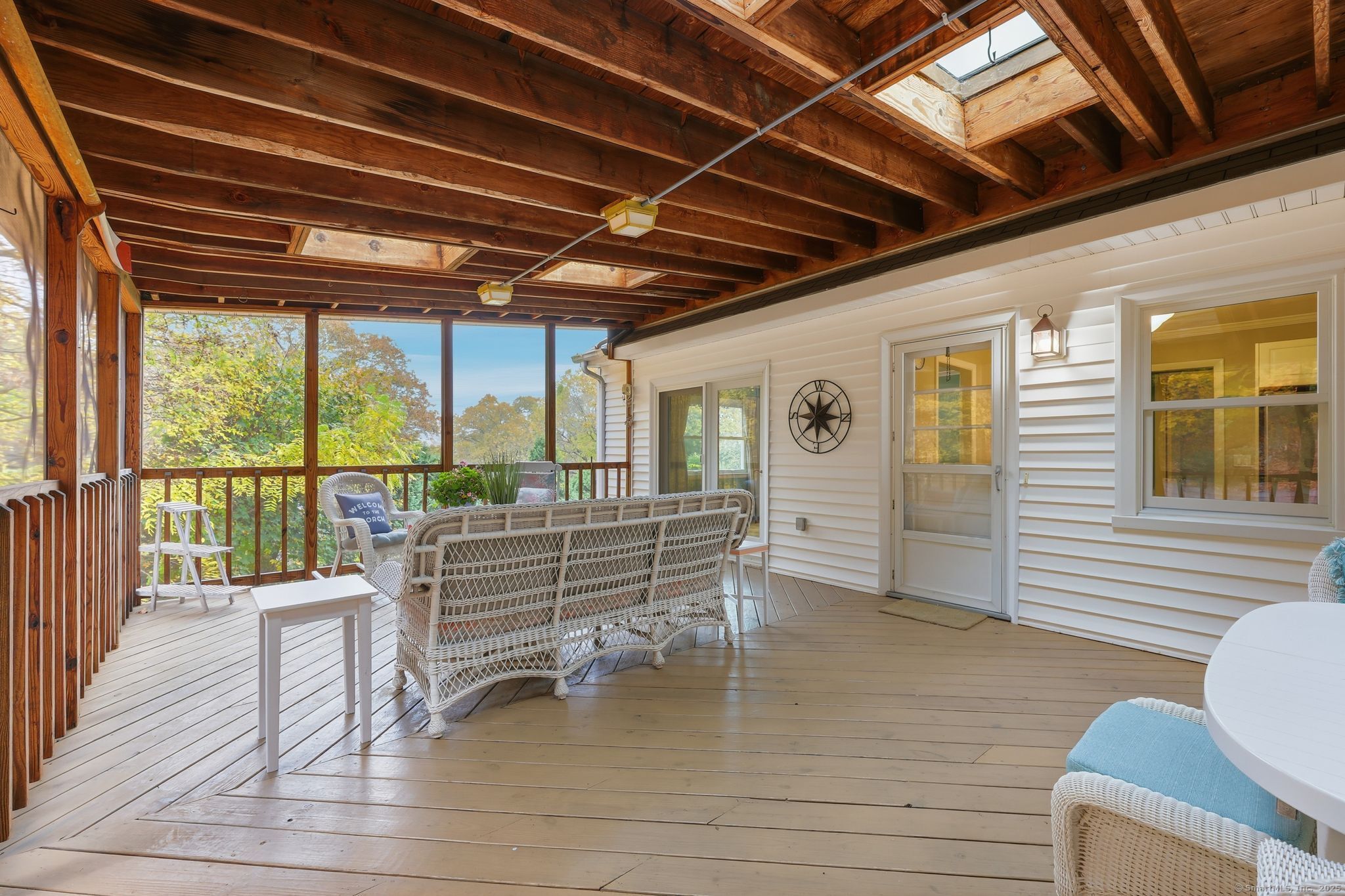 102 Lucas Park Road Norwich, CT 06360 - Photo 22 of 37 a view of a patio with a table chairs and wooden floor