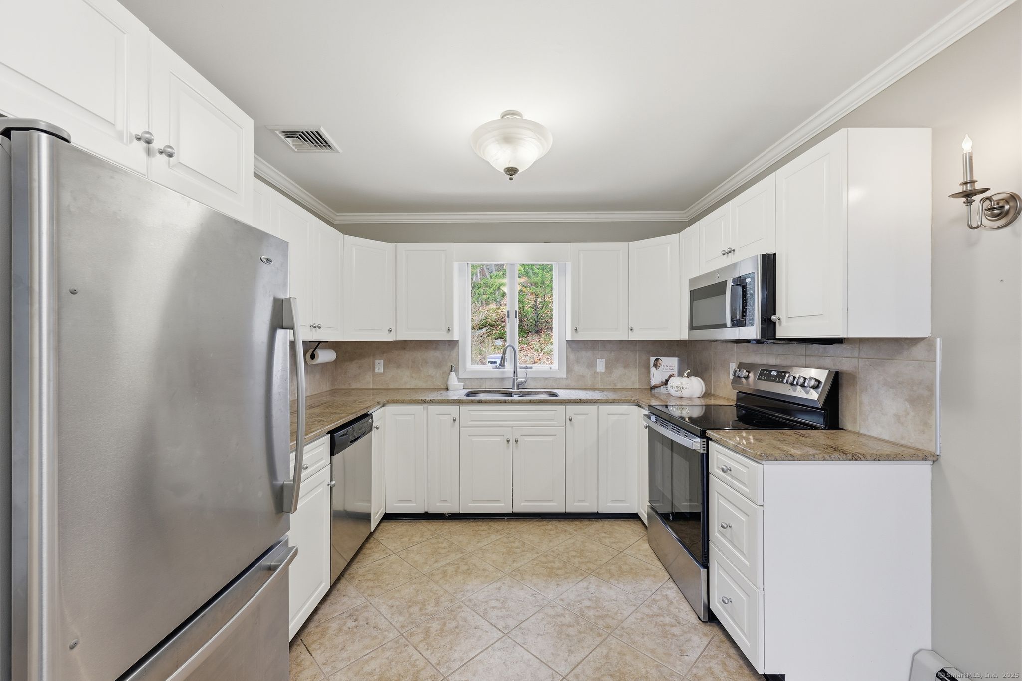 102 Lucas Park Road Norwich, CT 06360 - Photo 6 of 37 a kitchen with stainless steel appliances granite countertop a refrigerator and a stove top oven