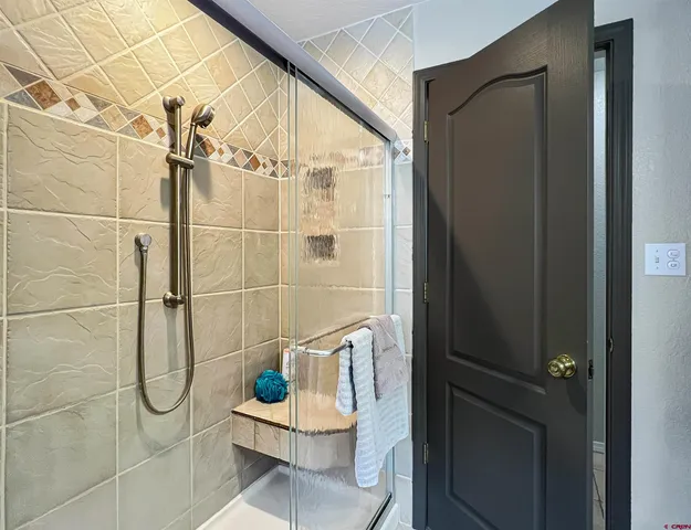 a bathroom with a glass shower door