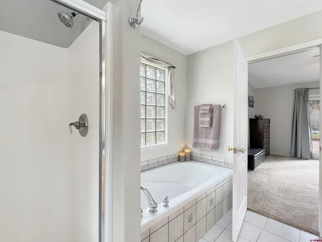 a spacious bathroom with a tub shower and sink