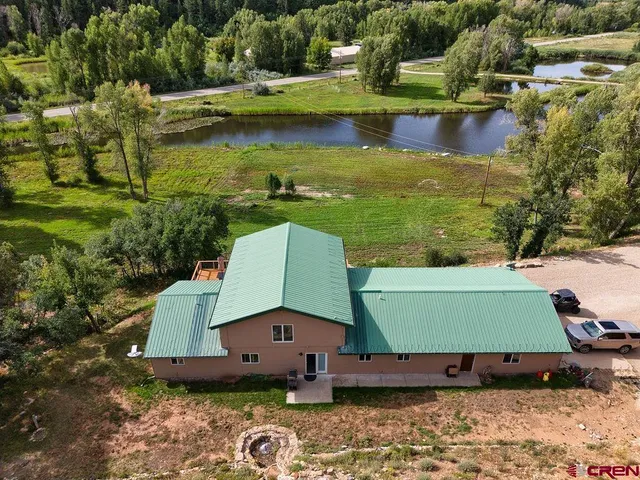 an aerial view of a house with a yard basket ball court and outdoor seating