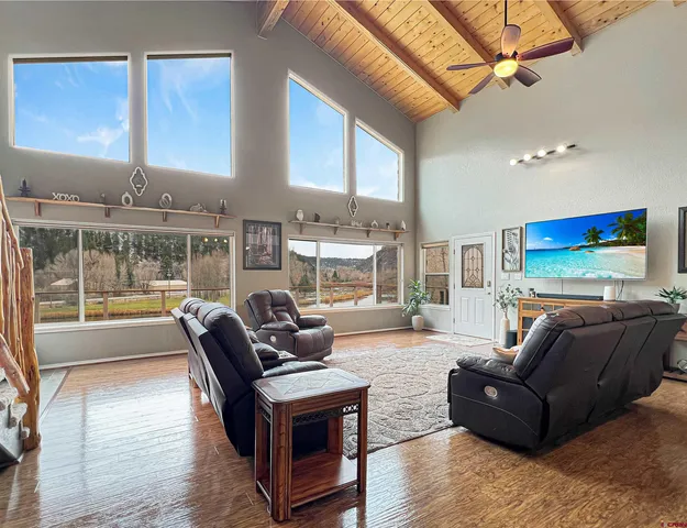 a living room with furniture and large windows