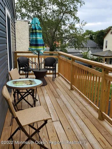 a view of a chairs and table on the balcony