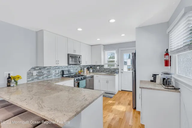 a kitchen with a sink a stove and chairs