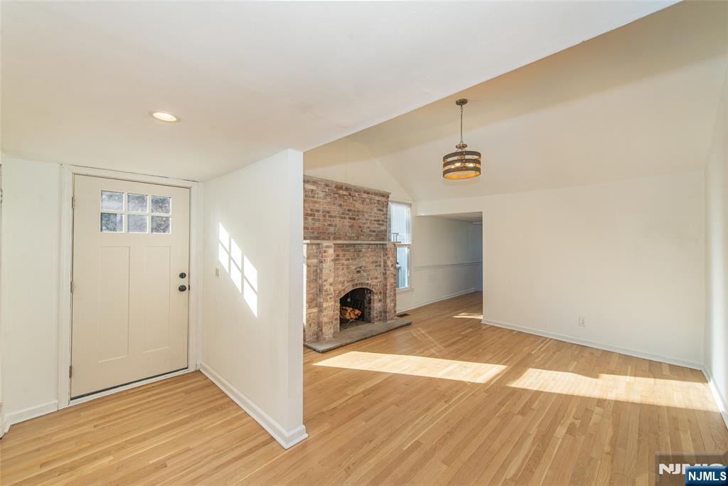 6 Berton Road Boonton, NJ 07005 - Photo 22 of 32 an empty room with wooden floor fireplace and windows
