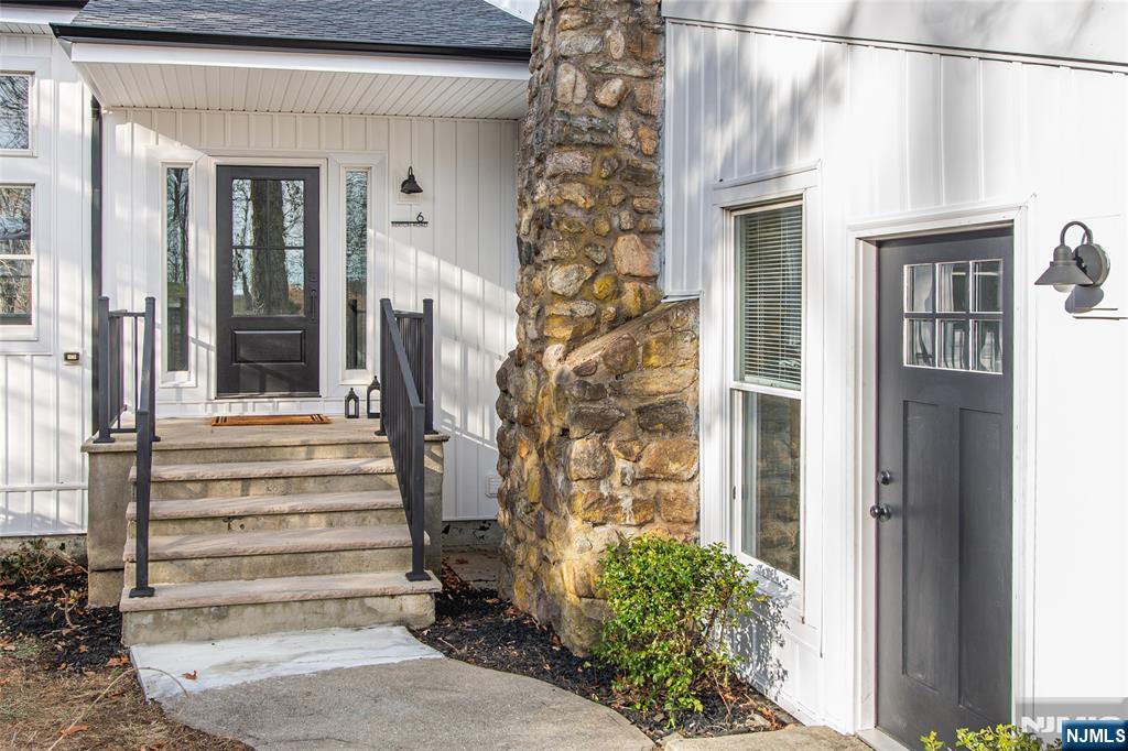 6 Berton Road Boonton, NJ 07005 - Photo 4 of 32 a view of a house with a door and wooden bench