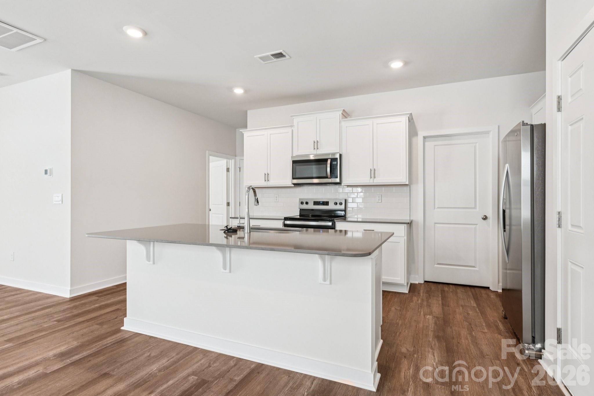 1447 Mammoth Road Hickory, NC 28602 - Photo 8 of 42 a kitchen with stainless steel appliances a sink stove and refrigerator