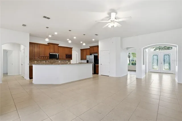 a view of kitchen with cabinets and refrigerator