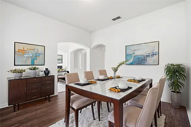 a view of a dining room with furniture and wooden floor