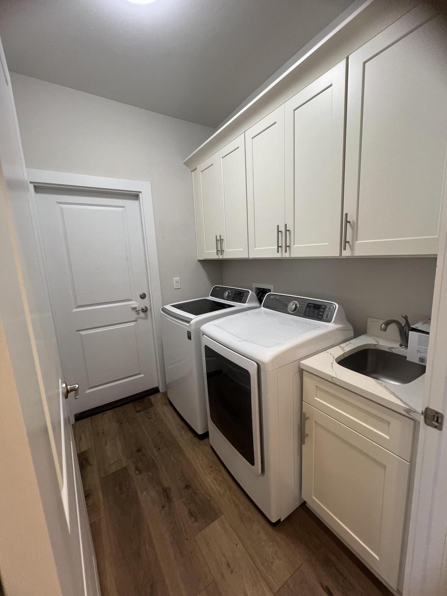 201 Marsh Landing South Freeport, FL 32439 - Photo 11 of 19 a view of washer and dryer with kitchen in the background