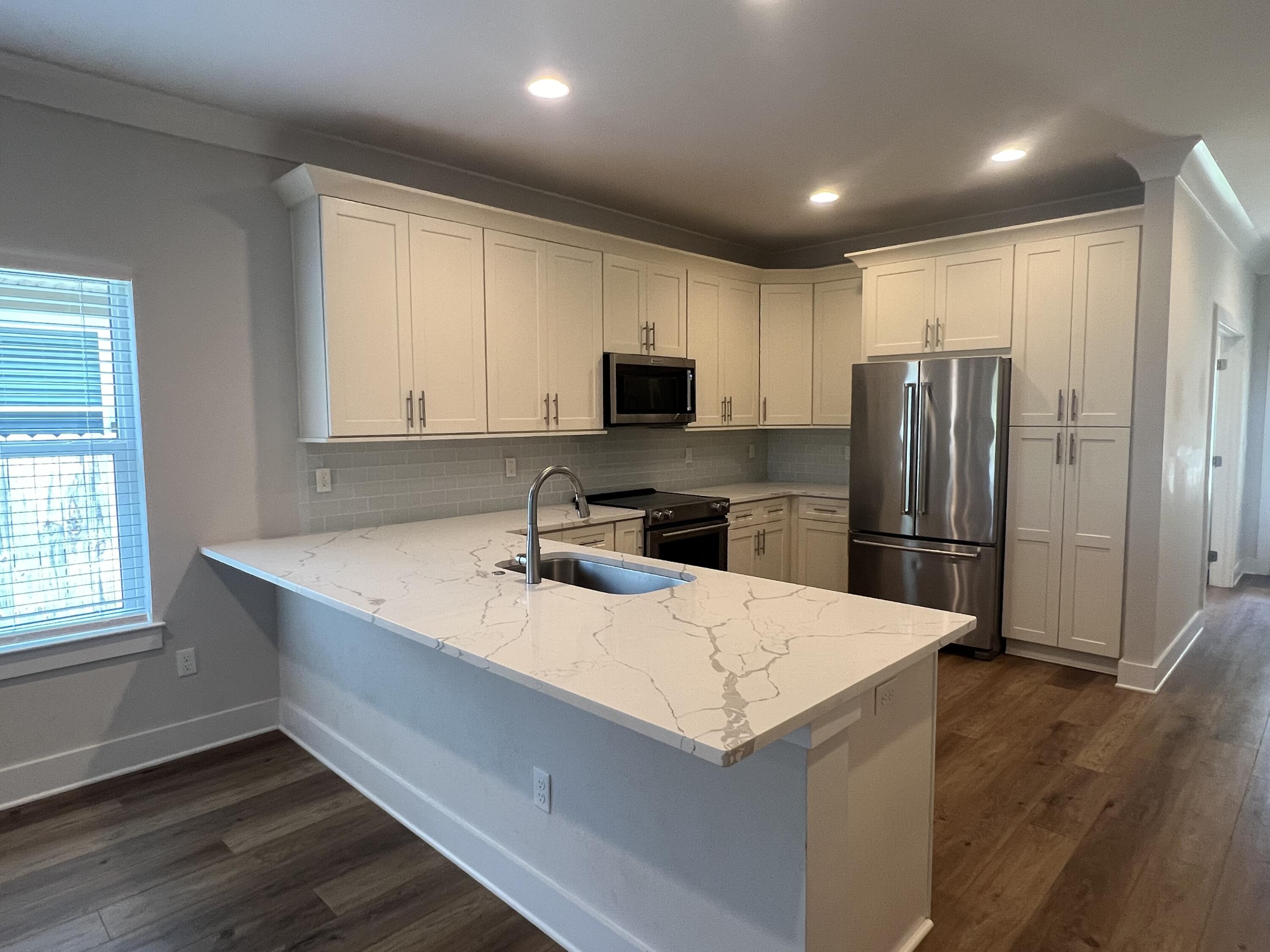 201 Marsh Landing South Freeport, FL 32439 - Photo 4 of 19 a kitchen with a refrigerator sink and microwave