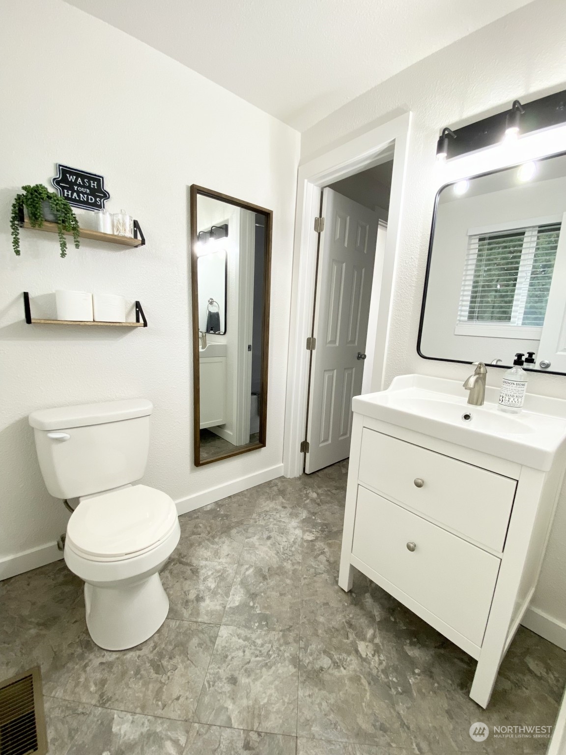 304 South Cleveland Street Kennewick, WA 99336 - Photo 12 of 12 a bathroom with a sink toilet a mirror and vanity
