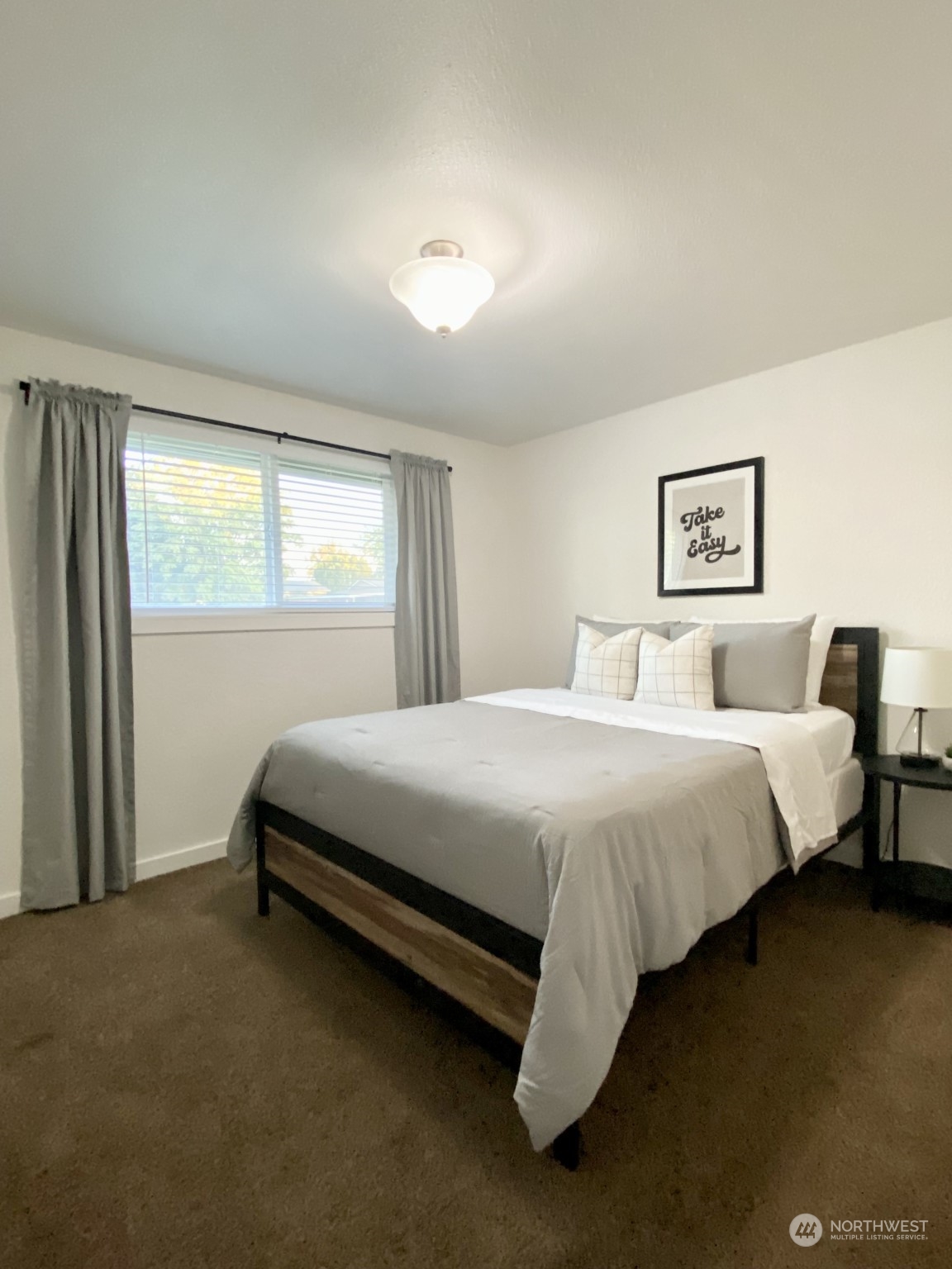 304 South Cleveland Street Kennewick, WA 99336 - Photo 2 of 12 a spacious bedroom with a bed and a window