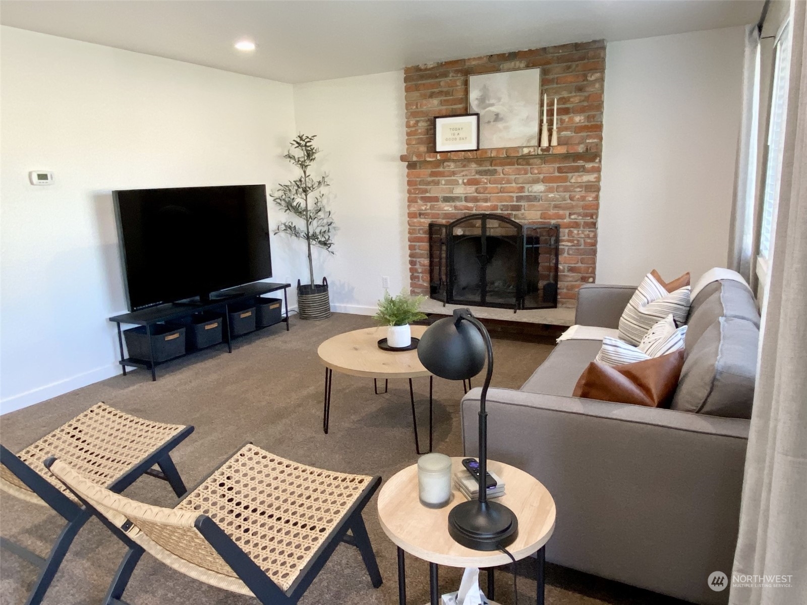 304 South Cleveland Street Kennewick, WA 99336 - Photo 3 of 12 a living room with furniture a flat screen tv and a fireplace