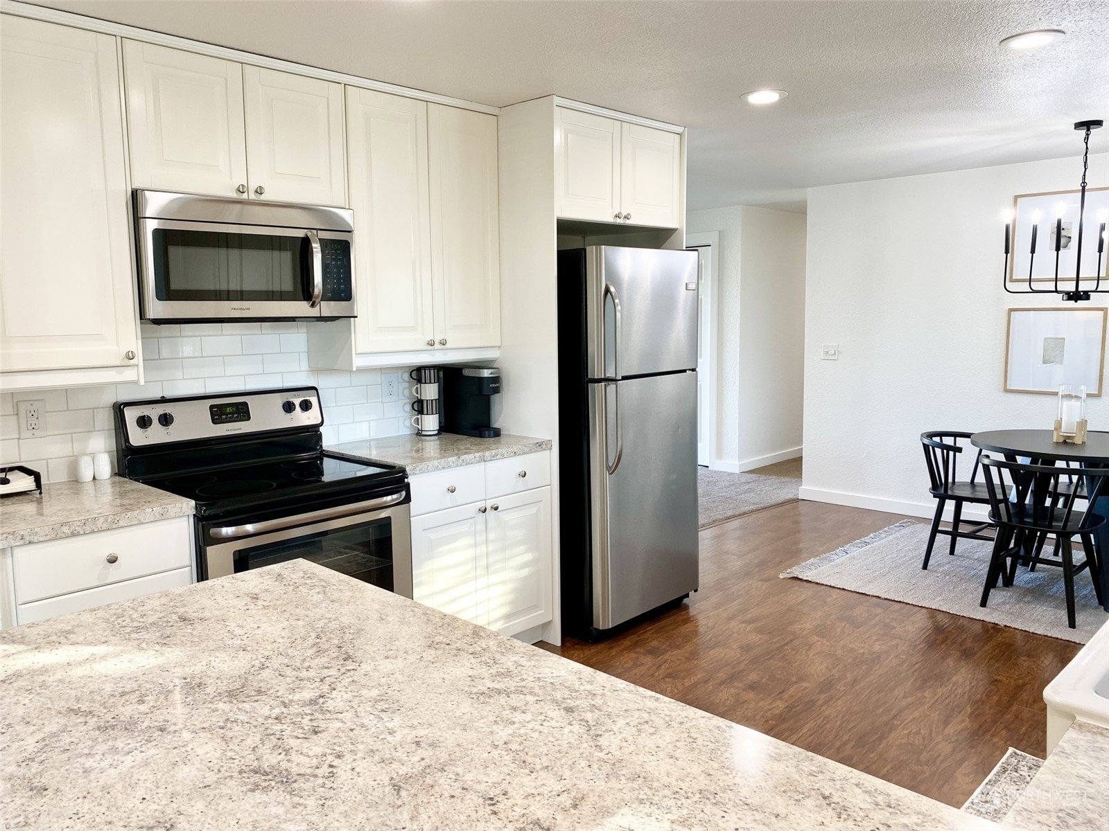 304 South Cleveland Street Kennewick, WA 99336 - Photo 6 of 12 a kitchen with a refrigerator and a stove top oven