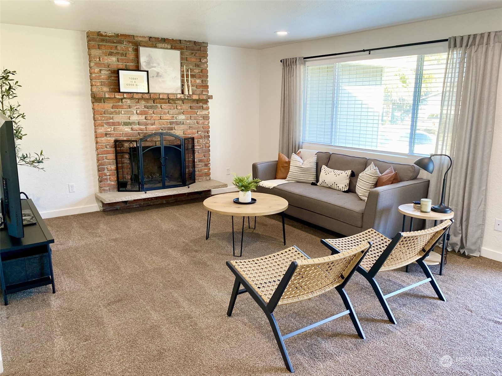 304 South Cleveland Street Kennewick, WA 99336 - Photo 7 of 12 a living room with furniture and a fireplace