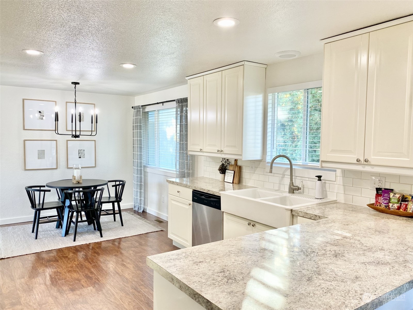 304 South Cleveland Street Kennewick, WA 99336 - Photo 9 of 12 a large kitchen with kitchen island a sink table and chairs