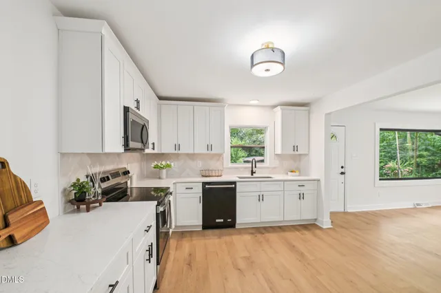 a kitchen with a sink stove and cabinets