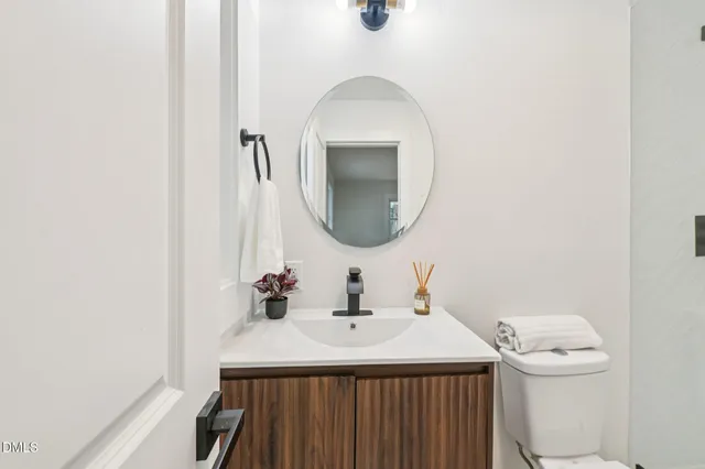 a bathroom with a sink a toilet and mirror