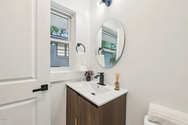a bathroom with a sink a mirror and a toilet