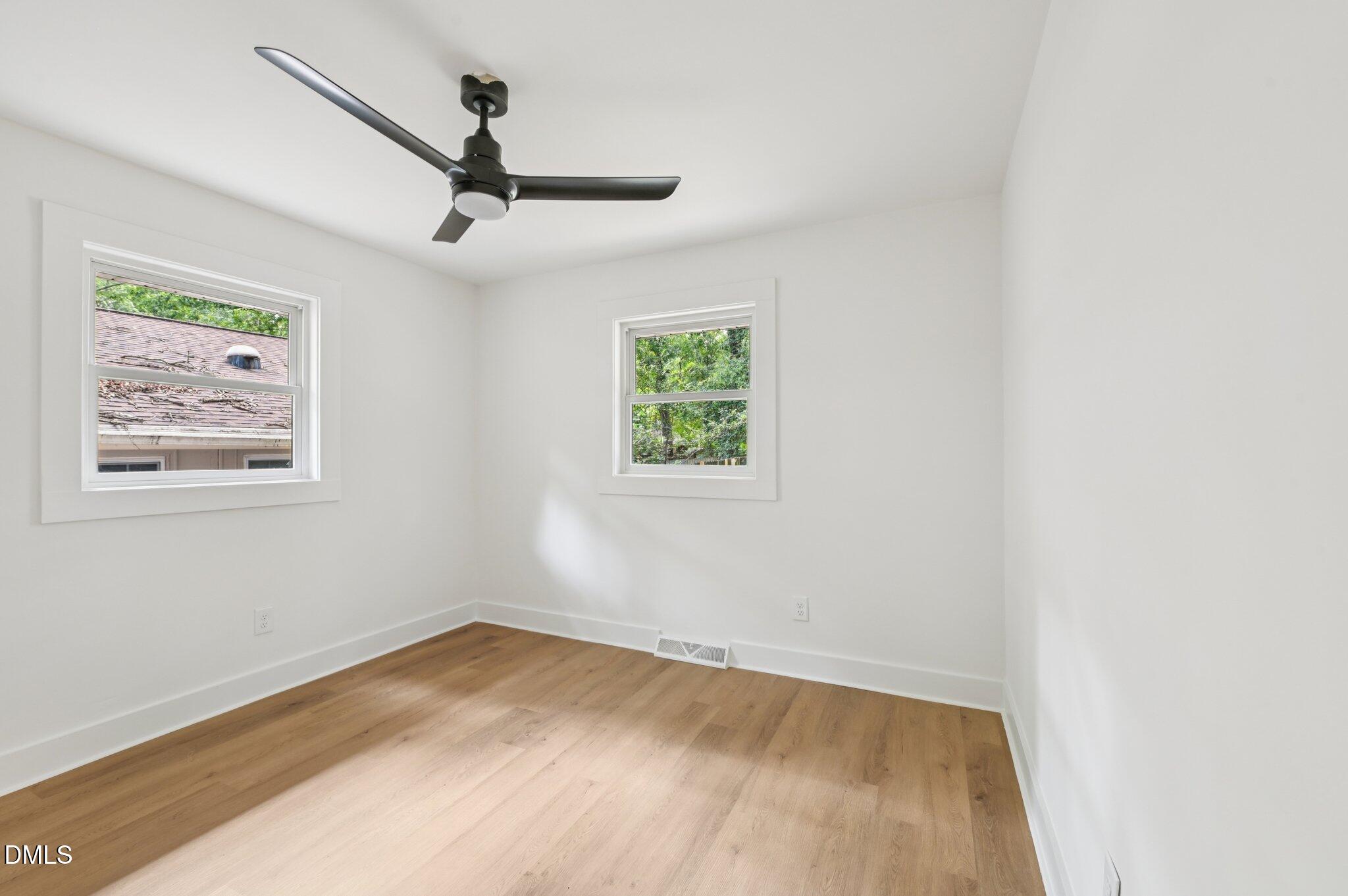 2708 Sarah Avenue Durham, NC 27707 - Photo 19 of 31 an empty room with wooden floor and windows