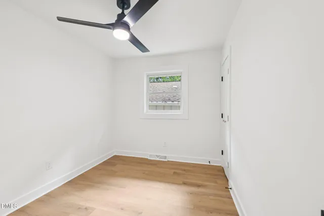 a view of room with window and ceiling fan