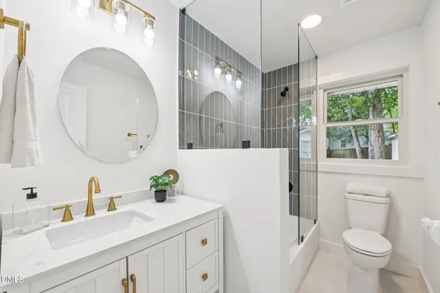 a bathroom with a sink a toilet and a mirror