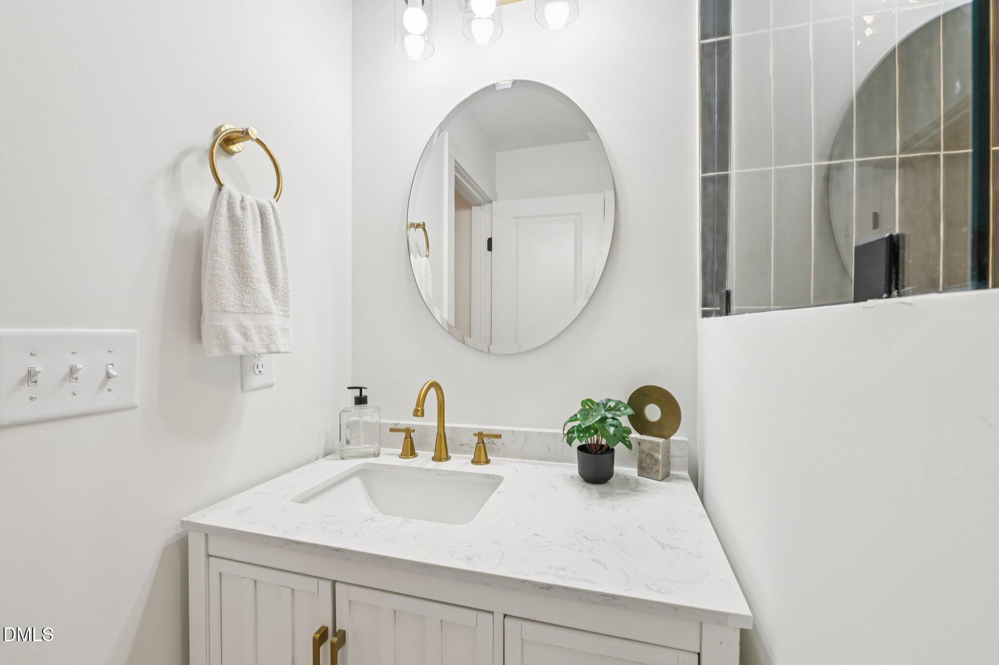 2708 Sarah Avenue Durham, NC 27707 - Photo 25 of 31 a bathroom with a sink and a mirror