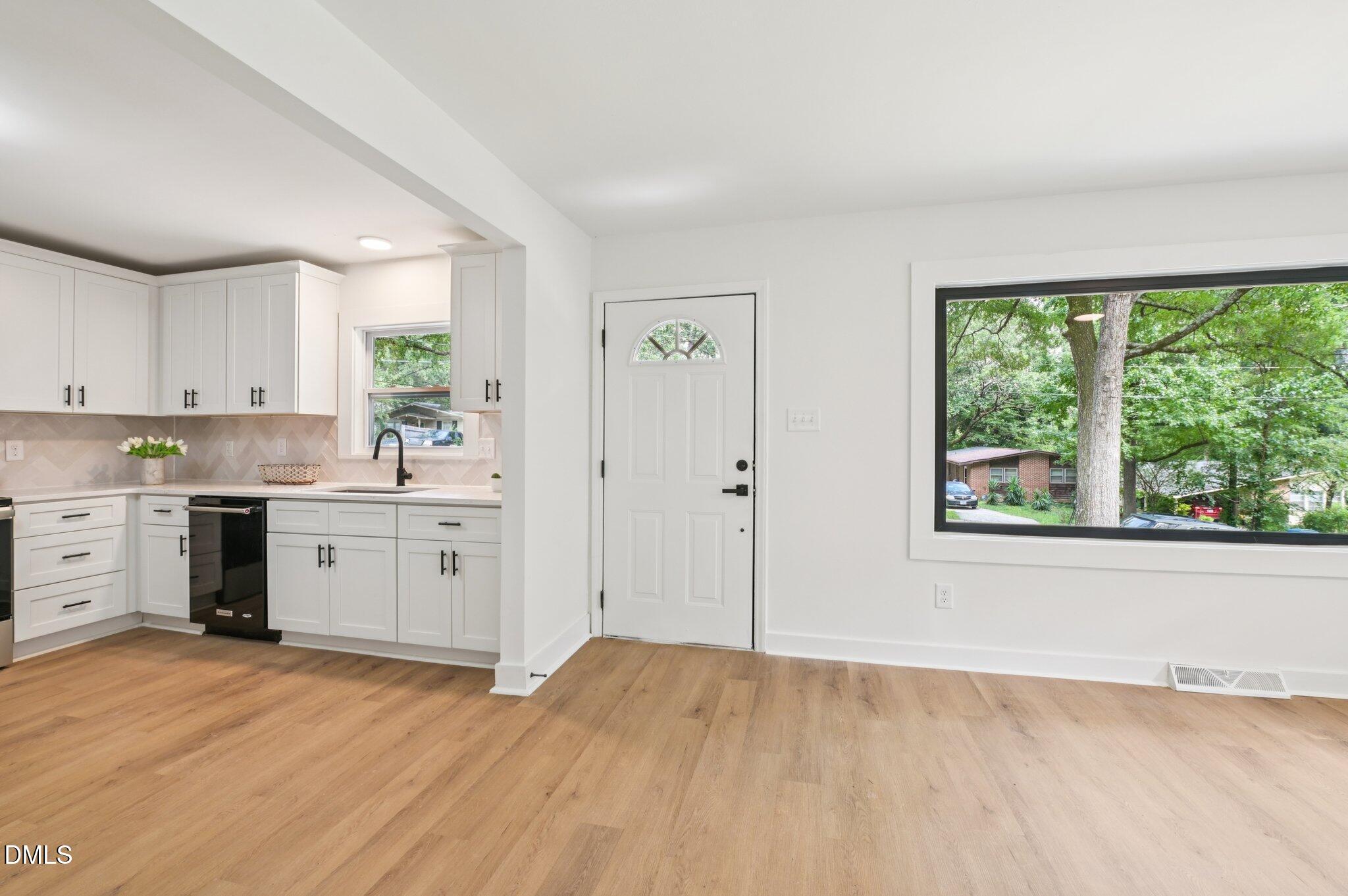 2708 Sarah Avenue Durham, NC 27707 - Photo 6 of 31 a kitchen with a stove a sink and a window