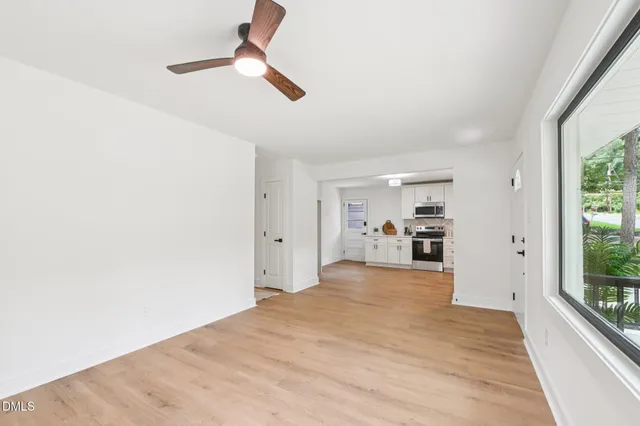 a view of a kitchen with a sink and a window