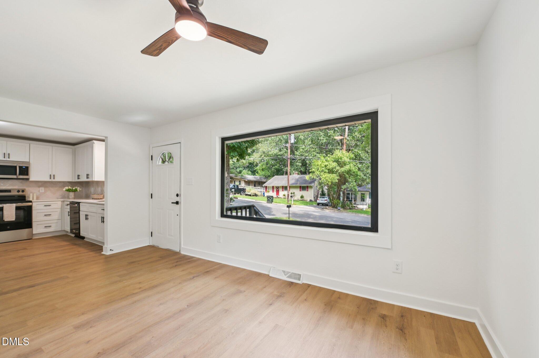 2708 Sarah Avenue Durham, NC 27707 - Photo 9 of 31 a view of a kitchen with wooden floor and a window