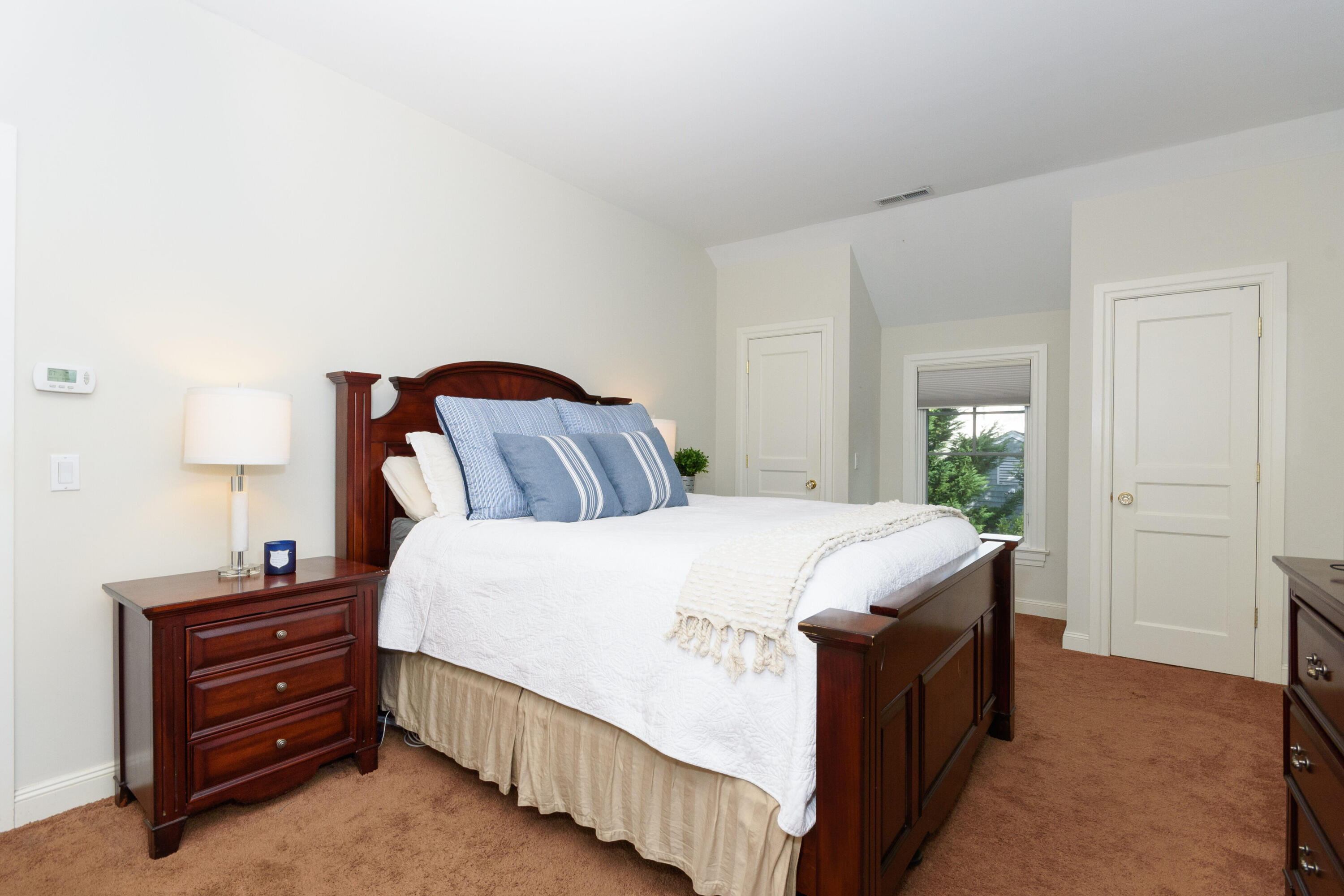 10 Mayflower Road Darien, CT 06820 - Photo 22 of 38 a bedroom with a bed and a lamp on dresser