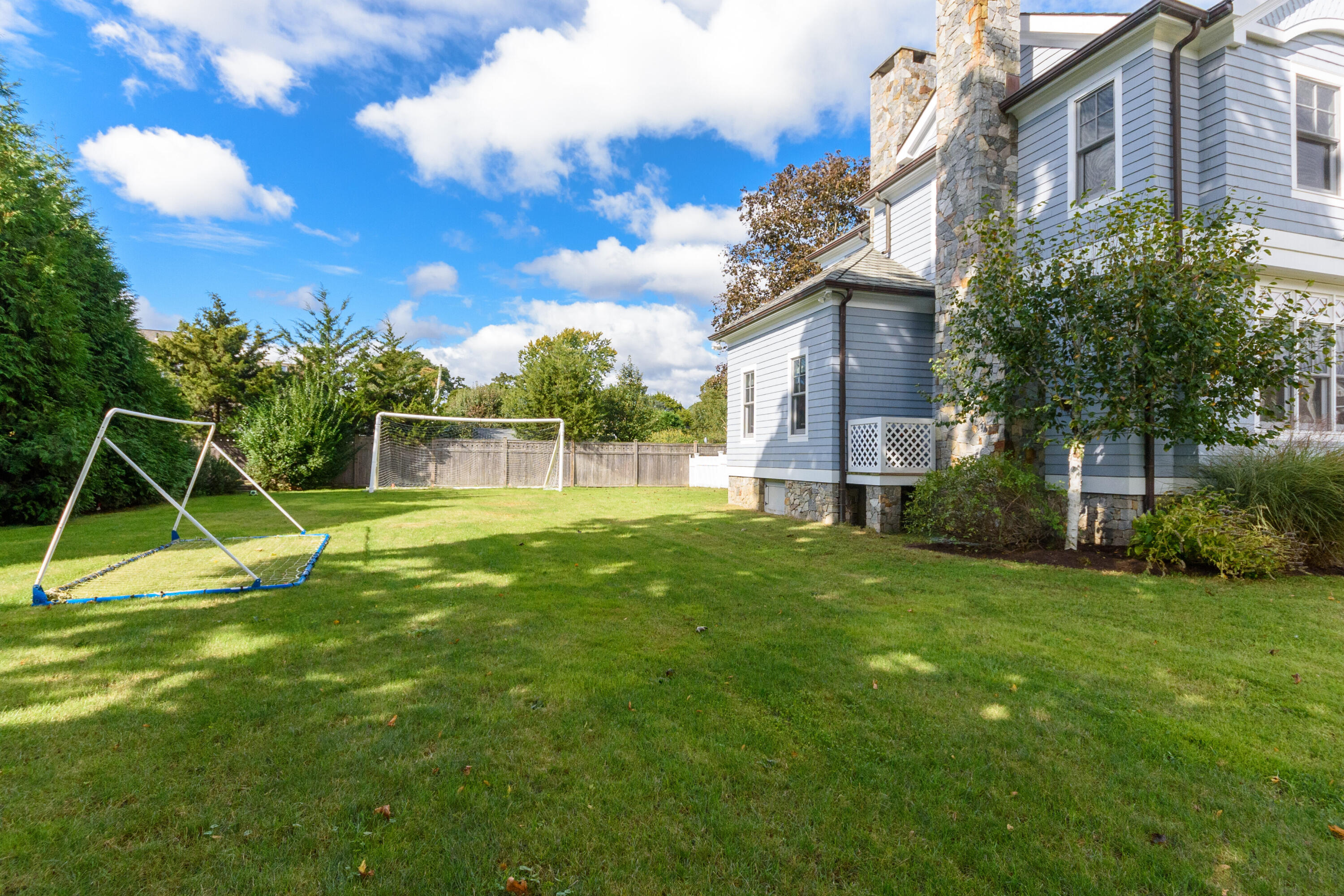 10 Mayflower Road Darien, CT 06820 - Photo 27 of 38 a view of a house with a backyard
