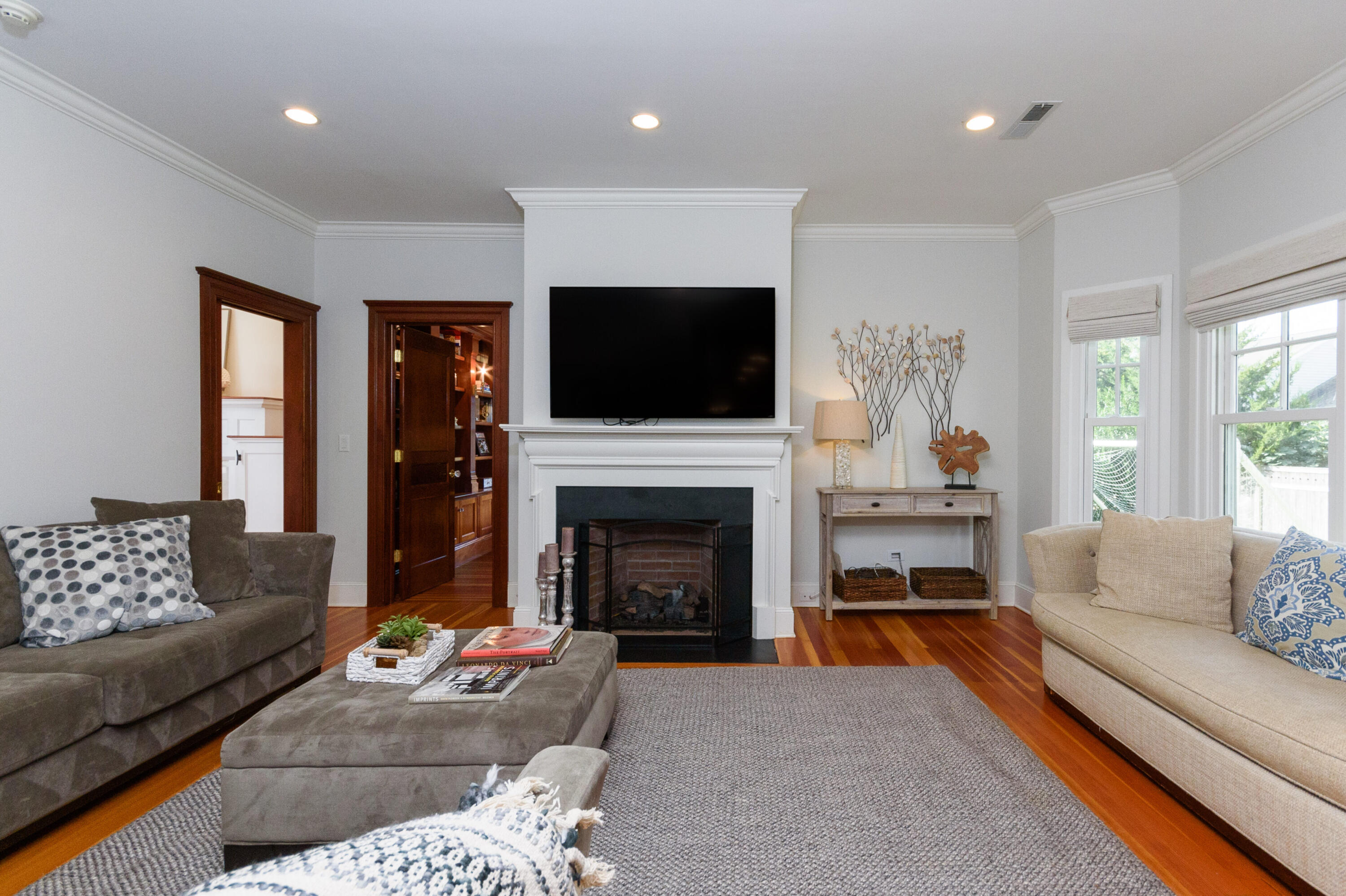 10 Mayflower Road Darien, CT 06820 - Photo 8 of 38 a living room with furniture a flat screen tv and a fireplace
