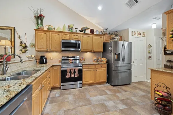 a kitchen with a refrigerator and a sink