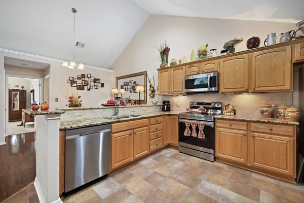 a kitchen with granite countertop stainless steel appliances and sink