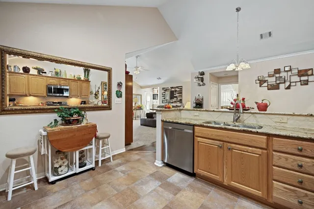 a kitchen with stainless steel appliances granite countertop a stove and cabinets