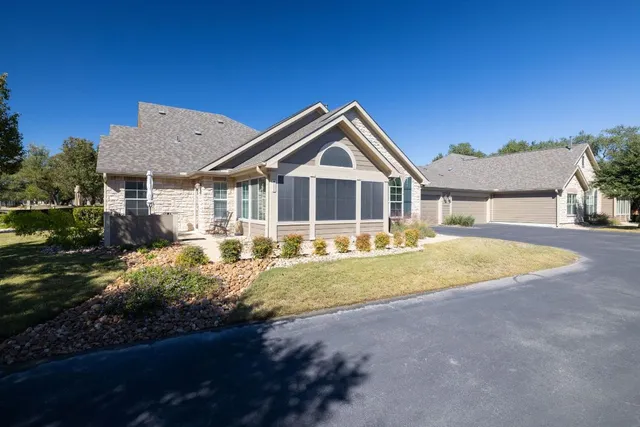 a view of a house with backyard and swimming pool