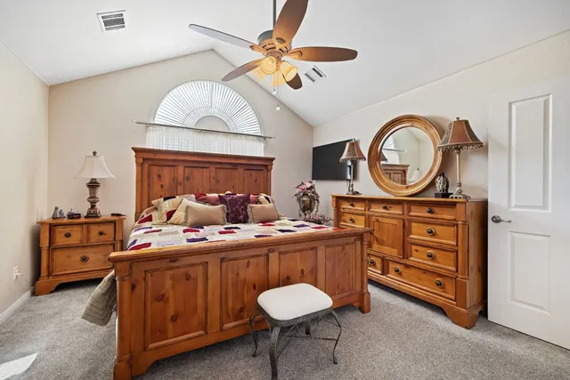a bed room with a bed and a chandelier
