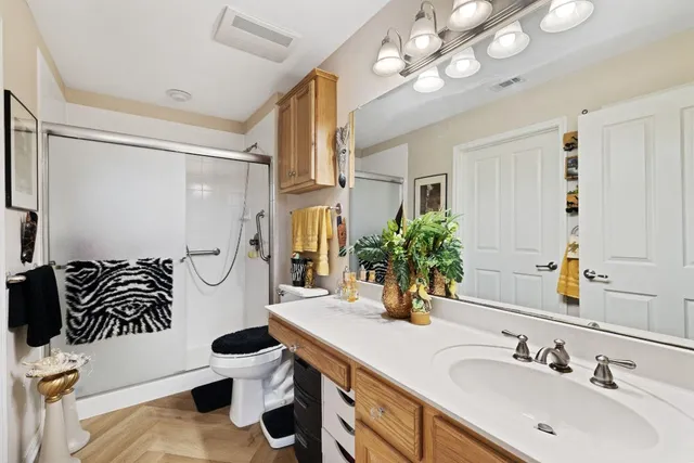 a bathroom with a sink a toilet and mirror
