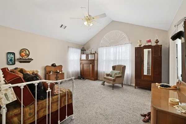 a living room with furniture a chandelier and a window