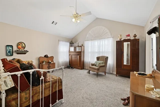 a living room with furniture a chandelier and a window