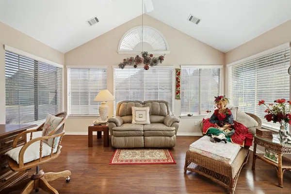 a living room with furniture and a chandelier