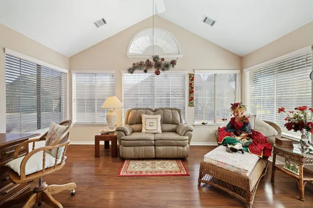 a living room with furniture and a chandelier