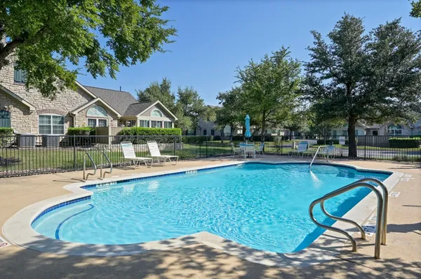 a view of a house with swimming pool and sitting area