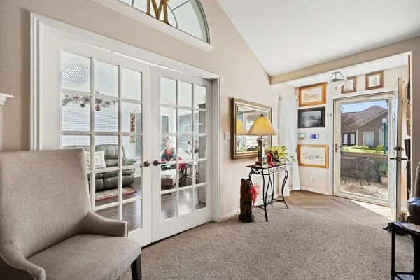 a view of a livingroom with furniture and floor to ceiling window
