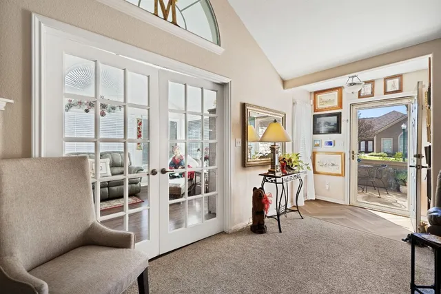 a view of a livingroom with furniture and floor to ceiling window